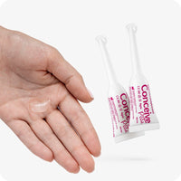 For Conceive Plus Max Combo - Fertility Lubricant Bundle (FR), featuring two pre-filled fertility lubricant applicators placed beside an open palm holding a small amount of fertility gel, visually demonstrating product texture and easy individual-use format for conception support.